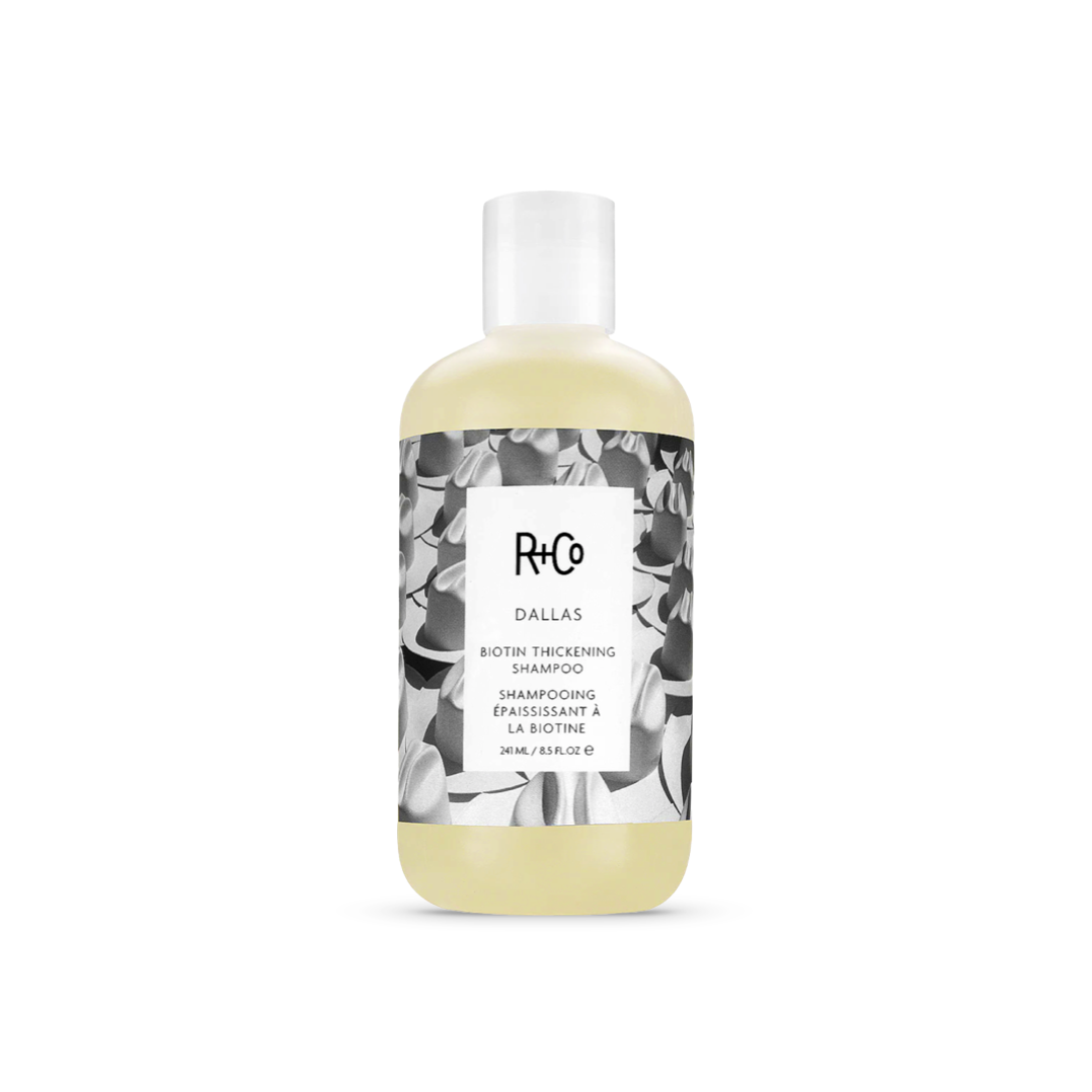 R+Co Dallas Biotin Thickening Shampoo bottle, 8.5 oz with black and white floral pattern design, for volumizing fine and flat hair.