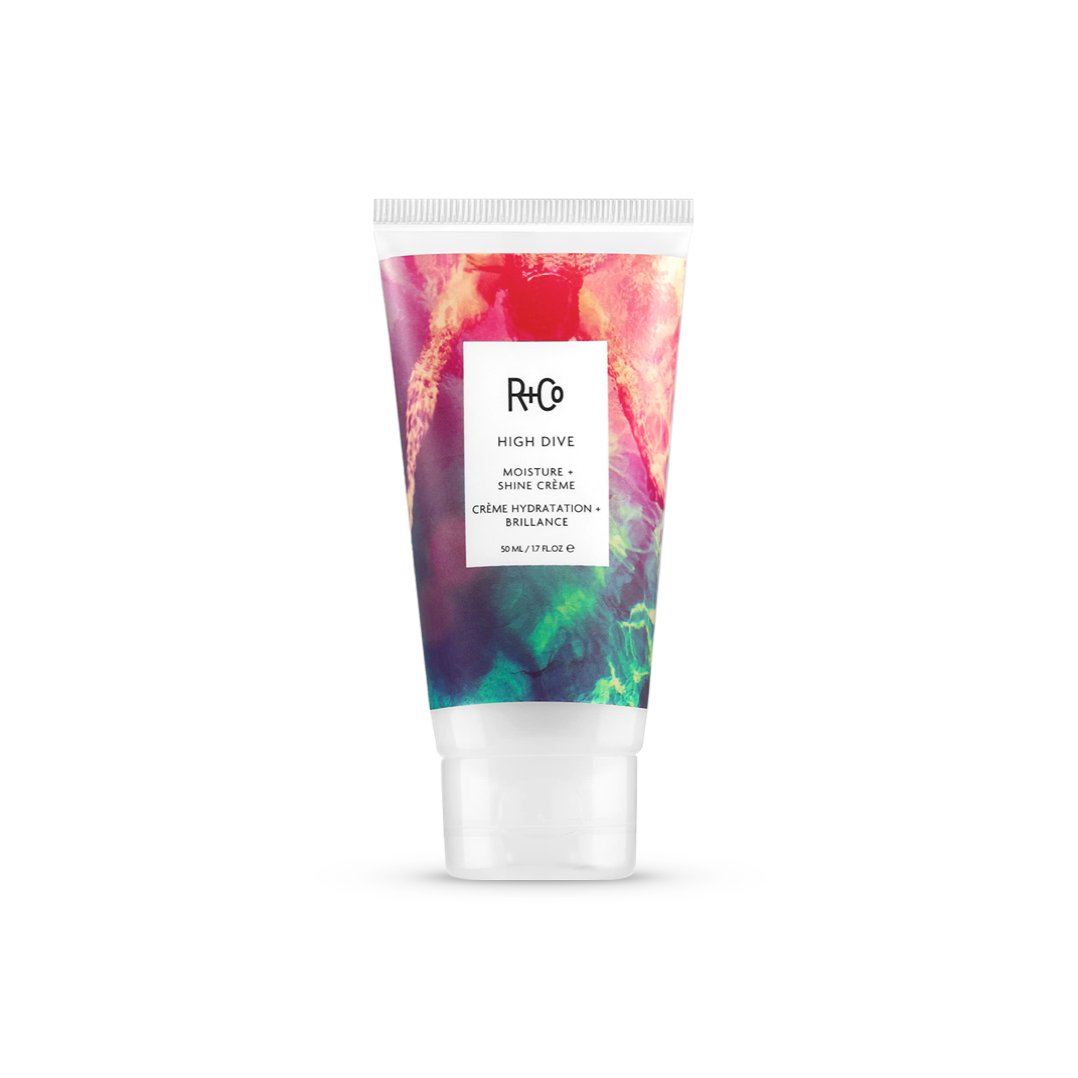 R+Co HIGH DIVE Moisture + Shine Crème in a 147ml tube with a colorful, abstract design, for hydrating and adding a lustrous sheen to hair.