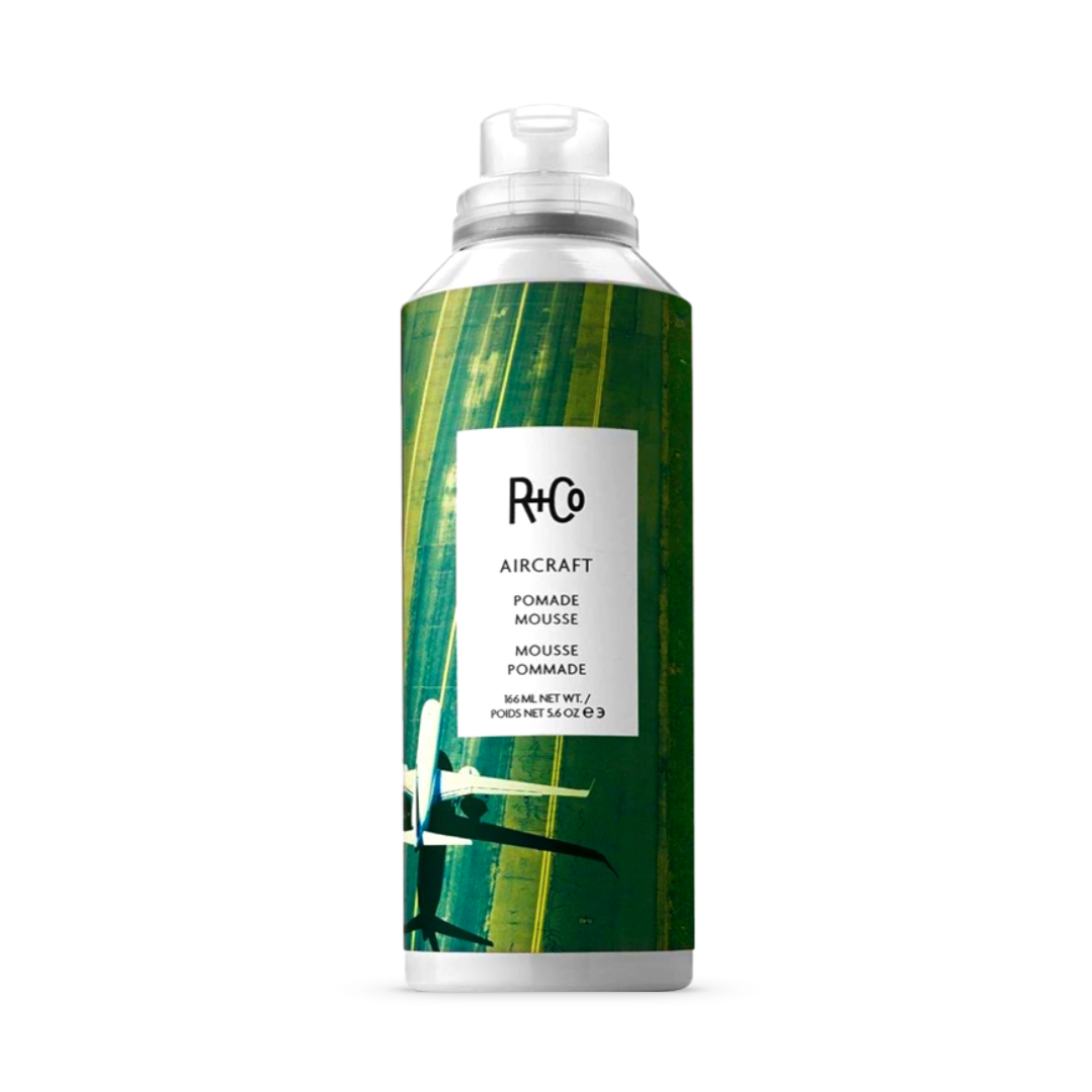 R+Co Aircraft Pomade Mousse, 6 oz bottle, for versatile styling and volumizing, with a green leafy design.