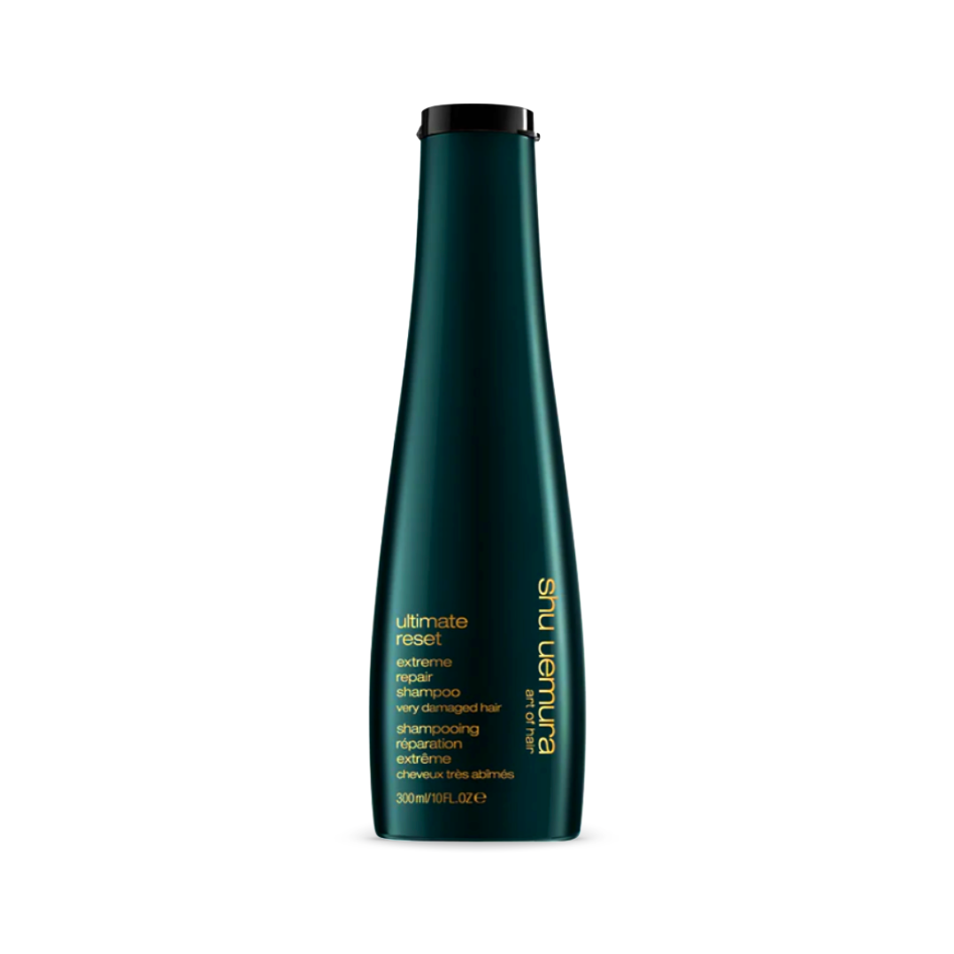 Elegant deep green bottle of Shu Uemura Ultimate Reset Extreme Repair Shampoo, 300ml/10fl.oz, designed specifically for very damaged hair. The shampoo promises a restorative cleansing experience, fortified with the power of rice extract for stronger, healthier hair.